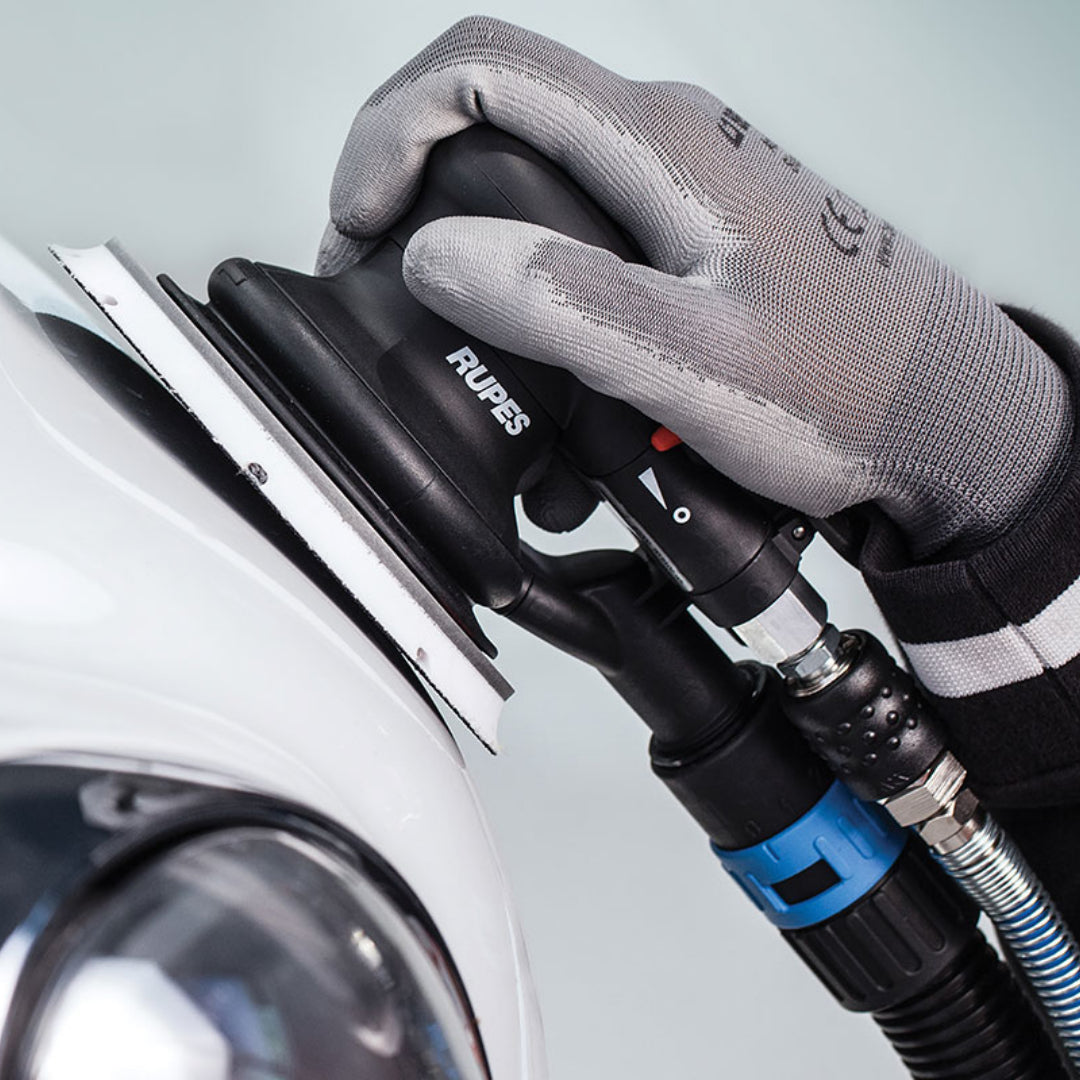 Rupes Skorpio III orbital air sander showing central vacuum port for workshop dust extractor connection