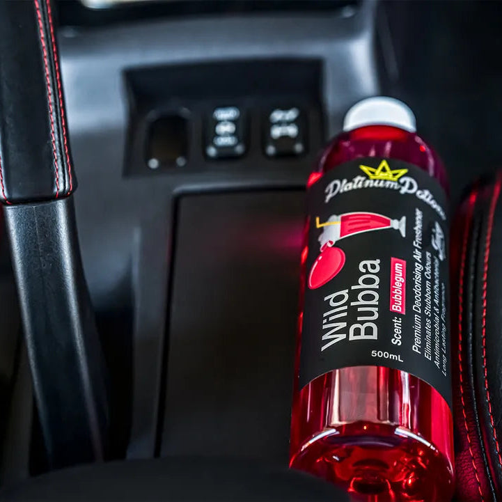 Red bottle of Wild Bubba juice in a car cup holder