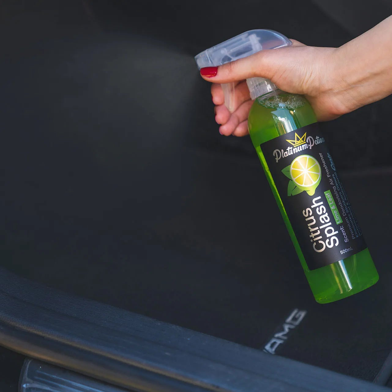 car air freshener being sprayed into a car interior