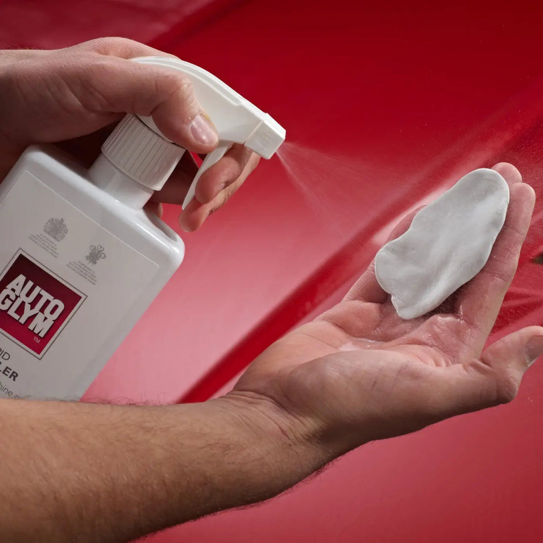 The Detail Warehouse Autoglym Clay Decontamination Kit including clay bar, rapid detailer, polish, and red cloth.