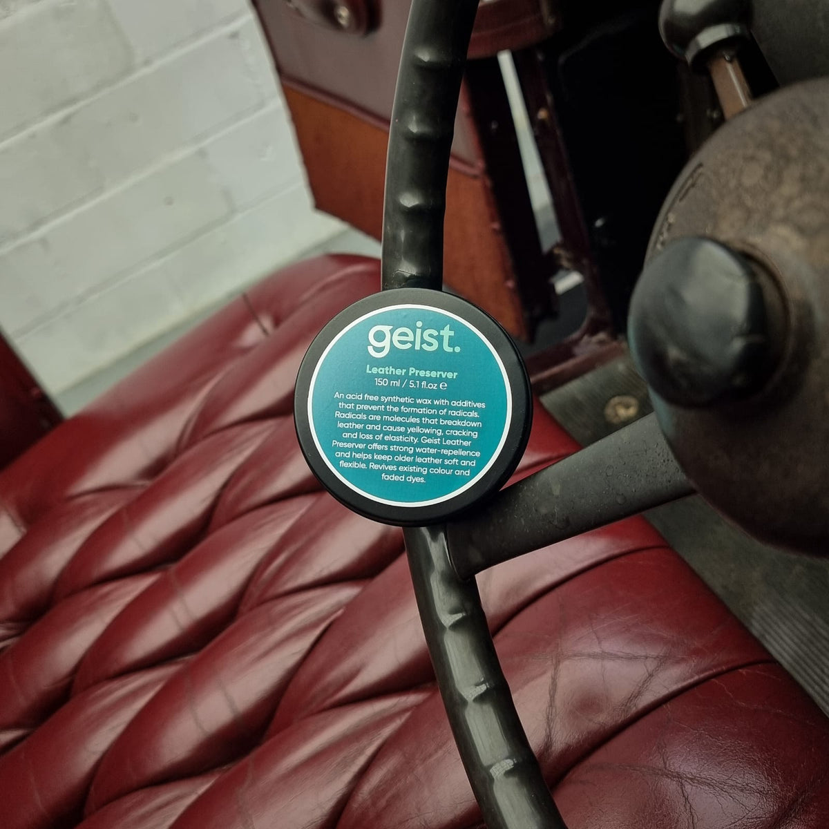 Close-up of a &#39;geist&#39; product on a leather surface with a blurred background