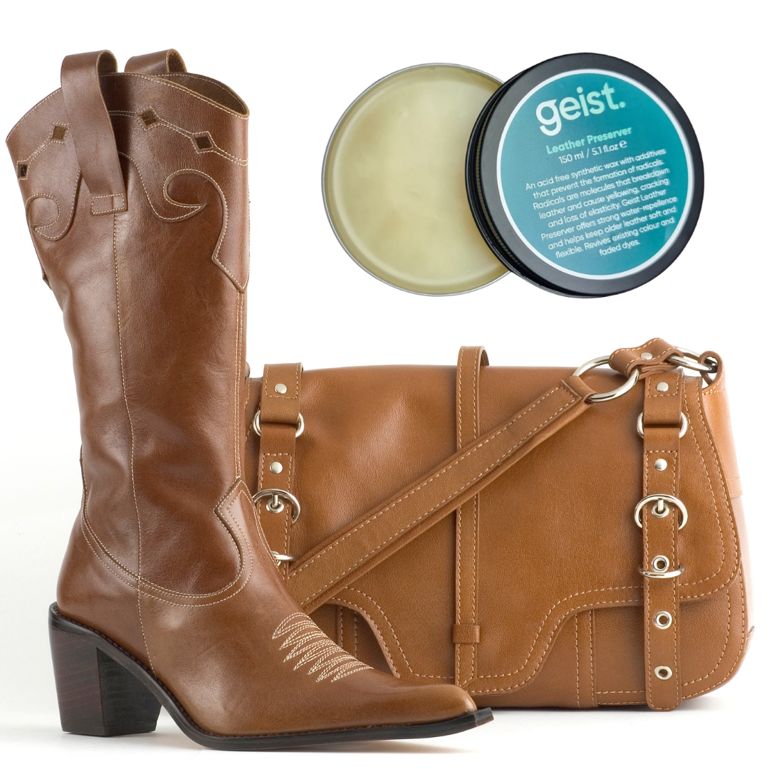 Brown leather boots and handbag with a container of 'geist' leather balm on a white background