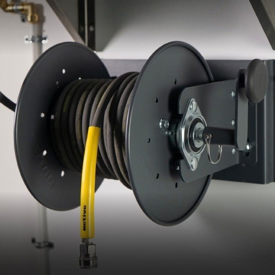 The Detail Warehouse ACTIVE M-Series steel pressure washer hose reel mounted on a wall with a coiled black hose.