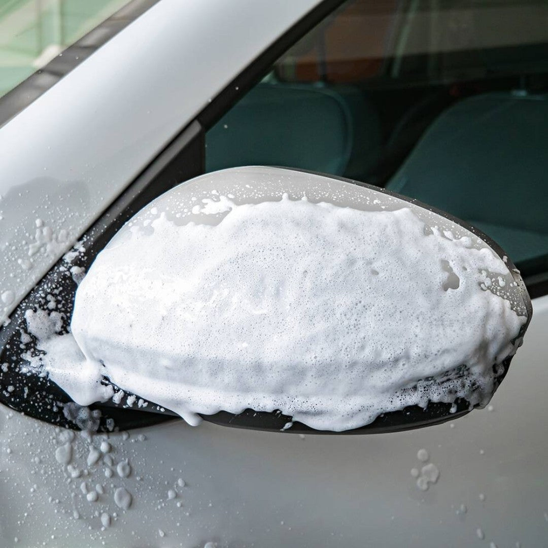 The Detail Warehouse Autoglym Active Insect Remover foam clinging to a white car side mirror to dissolve bug splatter