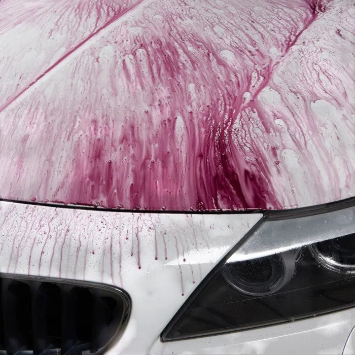 The Detail Warehouse Autoglym Magma active paint decontamination turning purple as it reacts with iron on a white car