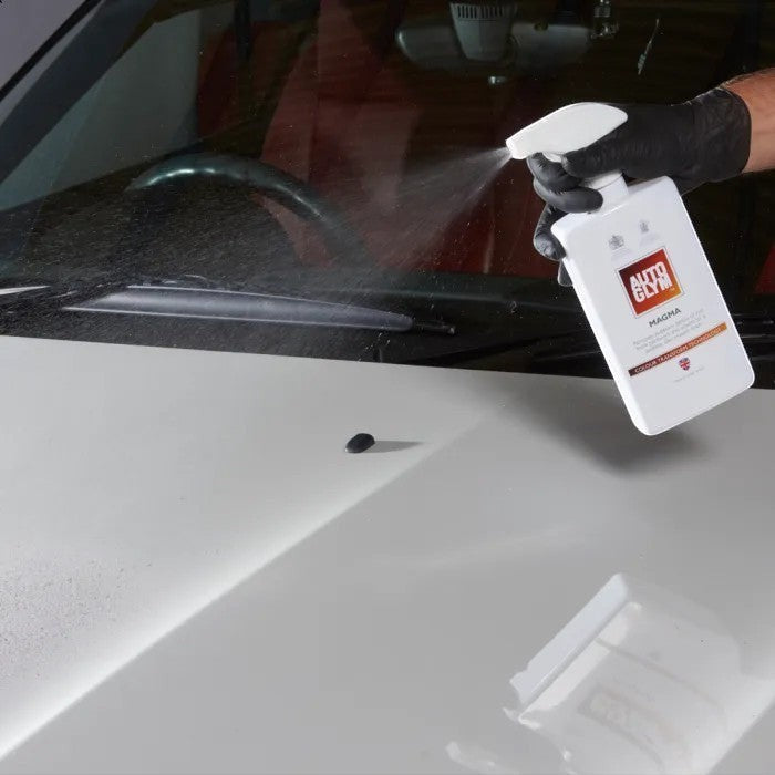 The Detail Warehouse Autoglym Magma spray bottle applying iron decontamination cleaner to a white car hood