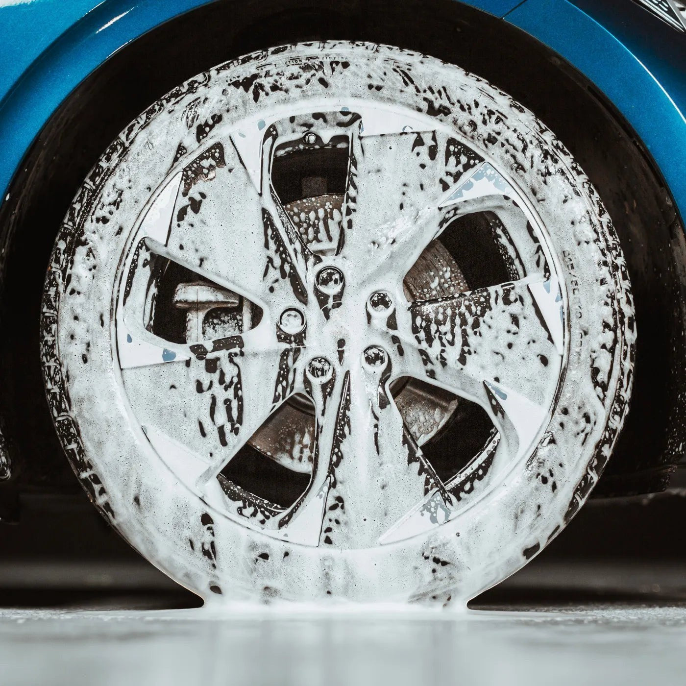 The Detail Warehouse Autoglym Custom Wheel Cleaner foam applied to a car alloy wheel to remove brake dust and grime