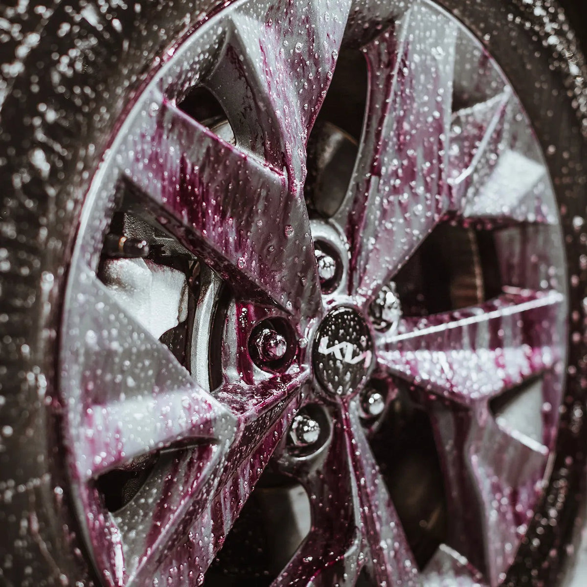 The Detail Warehouse Autoglym Advanced Wheel Cleaner reacting on a car wheel, turning deep purple to dissolve brake dust