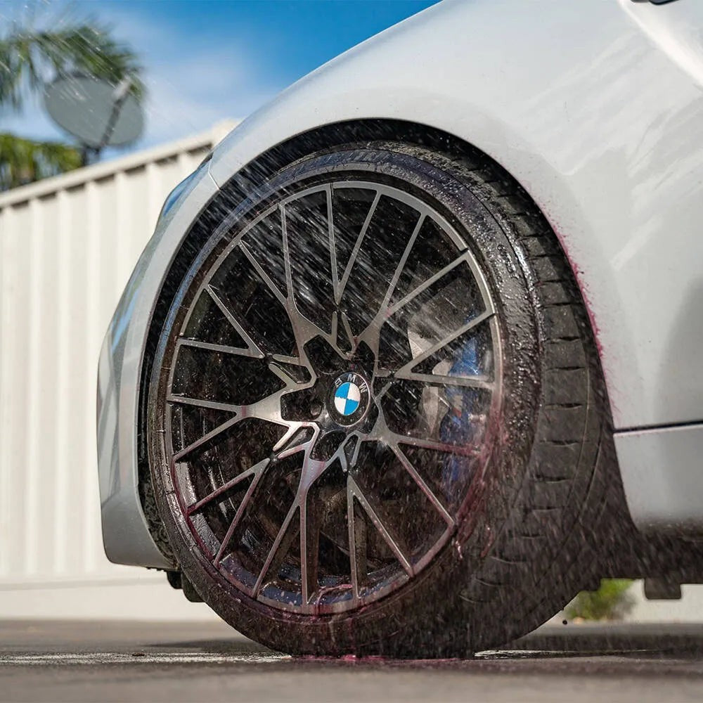 The Detail Warehouse Autoglym Advanced Wheel Cleaner spraying onto a car wheel, showing purple colour change reaction.