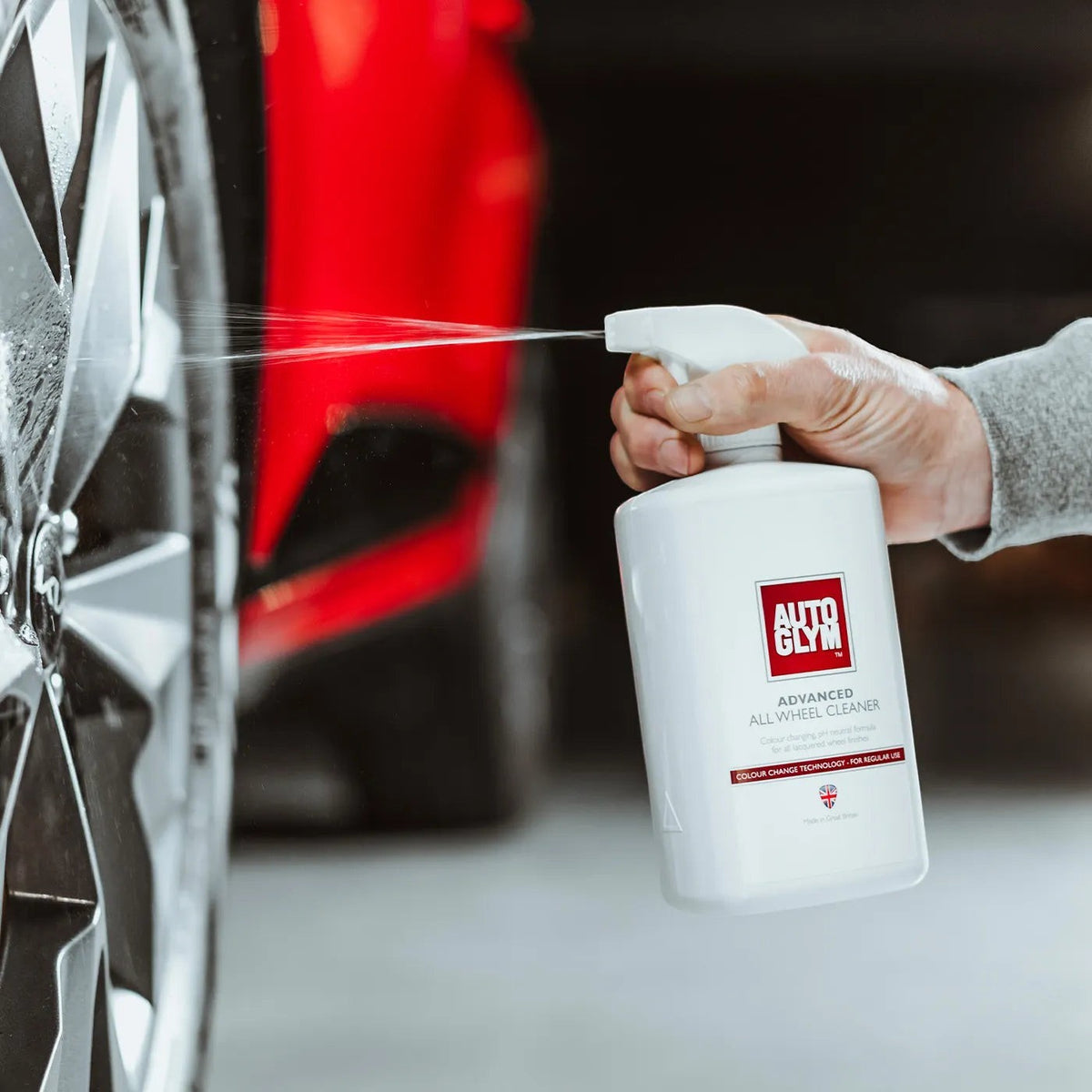 The Detail Warehouse Autoglym Advanced Wheel Cleaner spray bottle being used to clean a car wheel