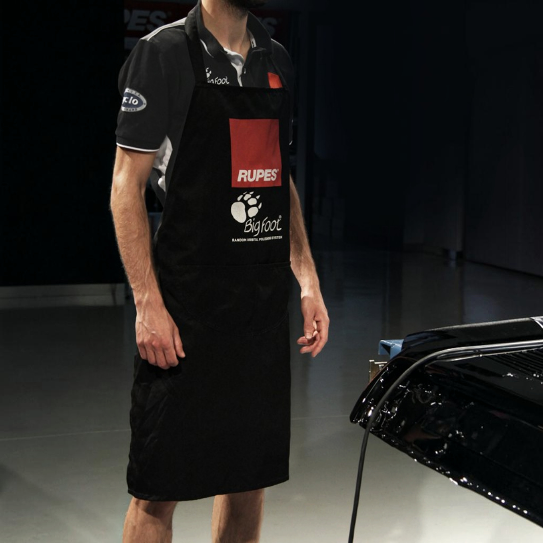 The Detail Warehouse Rupes Big Foot black polyester detailing apron with front pocket and logo branding