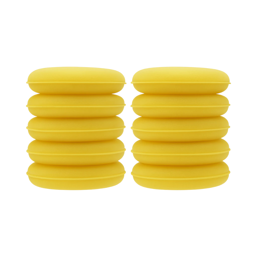The Detail Warehouse yellow foam wax applicators stacked in two columns for car detailing and polishing