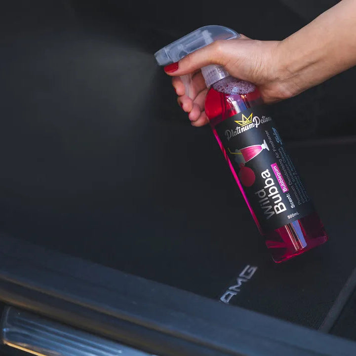 Person holding a Bubba brand bottle in a car trunk